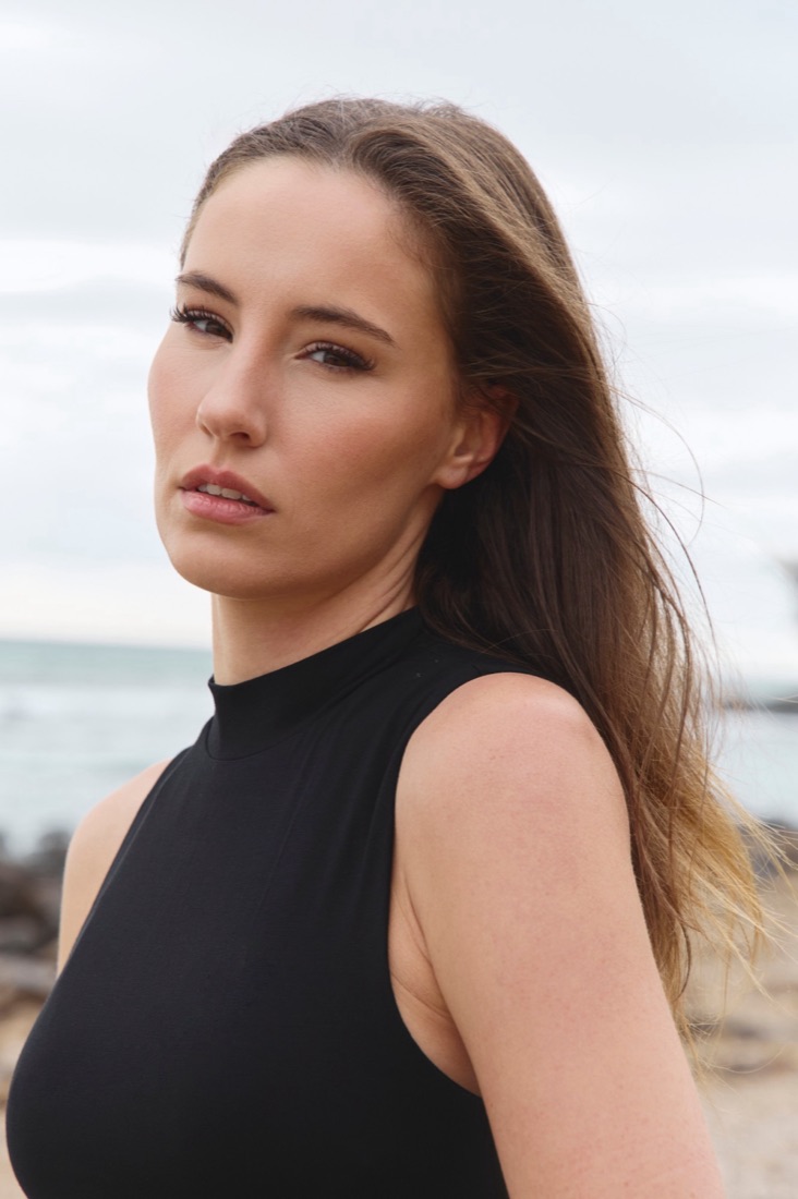 Close-up of soft bronzed skin, defined lashes and a nude lip